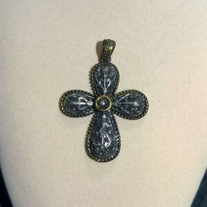 Antique style cross pendant with a black, silver and gold finish